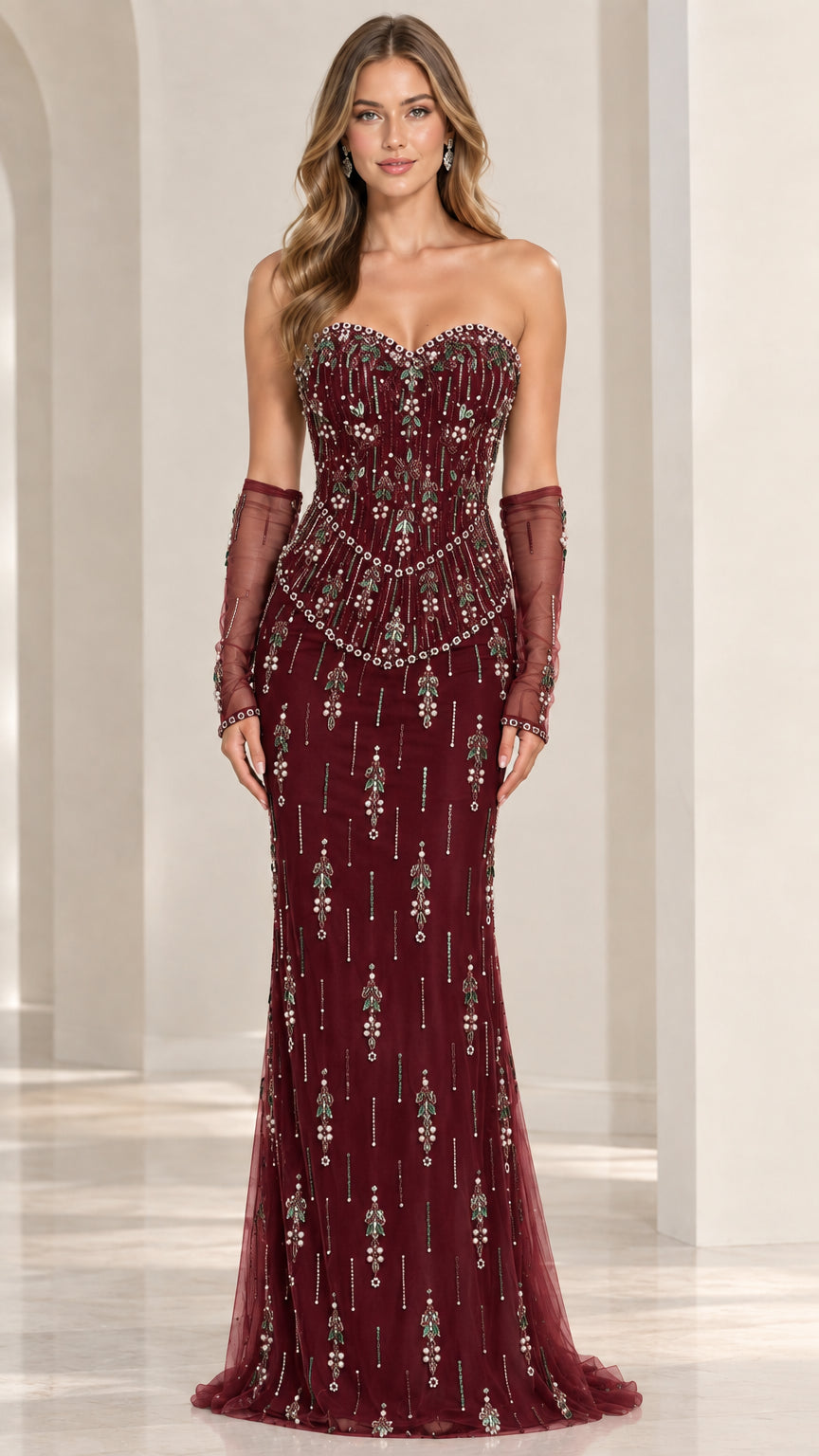 Front view of model wearing burgundy wine strapless beaded evening gown with sheer gloves
