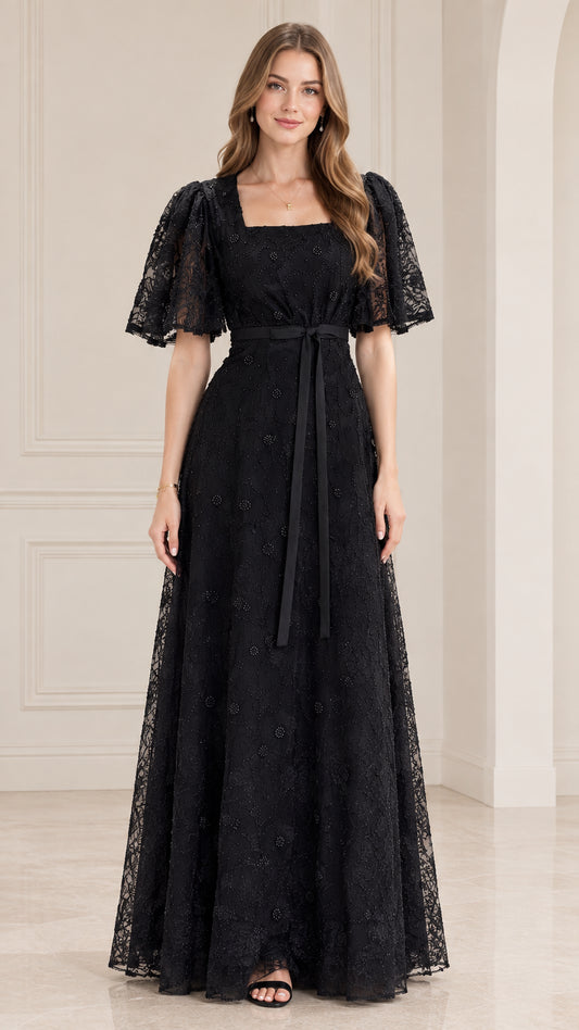 Front view of model wearing black square neck lace maxi dress with flutter sleeves