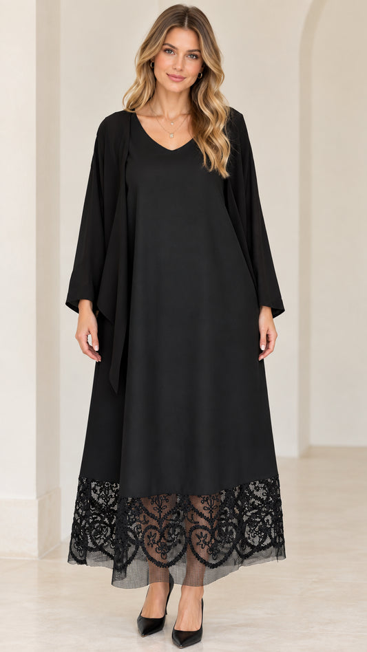 Front view of black V-neck maxi dress with sheer lace hem and draped cardigan overlay