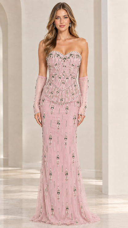 Front view of model wearing blush pink strapless beaded evening gown with sheer gloves